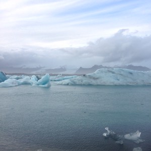 Jökulsárlón glacial lagoon blue icebergs against backdrop of mountains