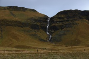 waterfall falling from a mossy hillside