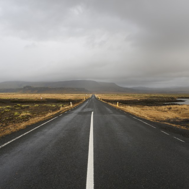 a tarmac road dissapearing into the distance